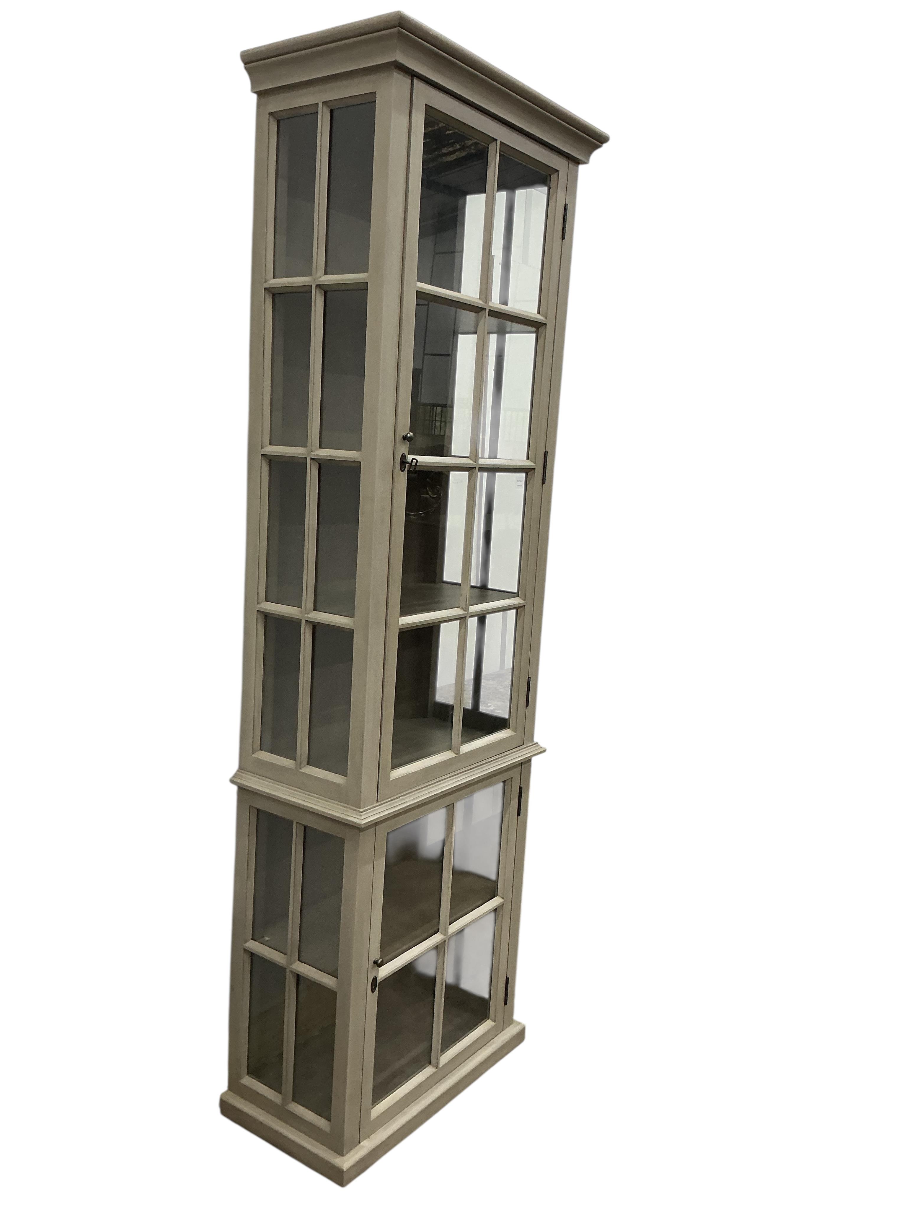 A Contemporary painted narrow cabinet, in two parts, width 73cm, depth 39cm, height 130cm